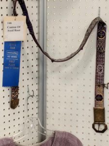 An ornately woven belt on display for the Iowa State Fair.